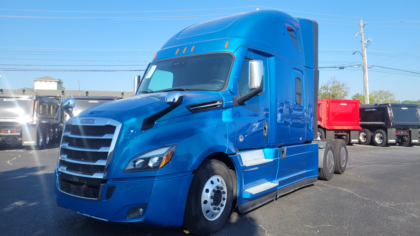 Freightliner Cascadia 126 tractor in blue, front three-quarter view, with sleeper cab and chrome mirrors.