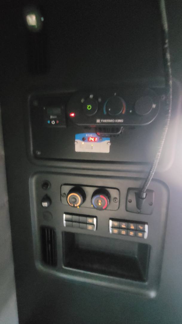 Dashboard control panel with HVAC dials and USB/aux slots inside Freightliner Cascadia 126 cabin.