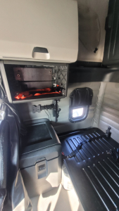 Cabin interior of 2022 Freightliner Cascadia 126 sleeper showing storage compartments and a work light with exposed tool area.