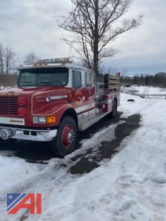 Fire truck in serviceable condition showing a red 1993 International Conventional Cab Pumper with front grille, mounted equipment at rear, and snow on ground.
