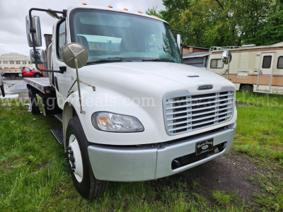 Front view of a white 2015 Freightliner M2 106 tow truck showing large grille, headlights, side mirrors, and front bumper.