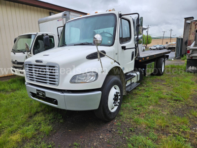 White Freightliner M2 106 tow truck, front-left view, side flatbed, chrome front grille, large mirrors, stock number plate visible.