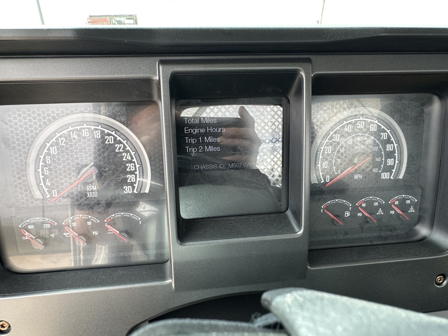 Dashboard view of a 2025 Mack MD7 showing instrument gauges, center display with trip information, and steering column area.