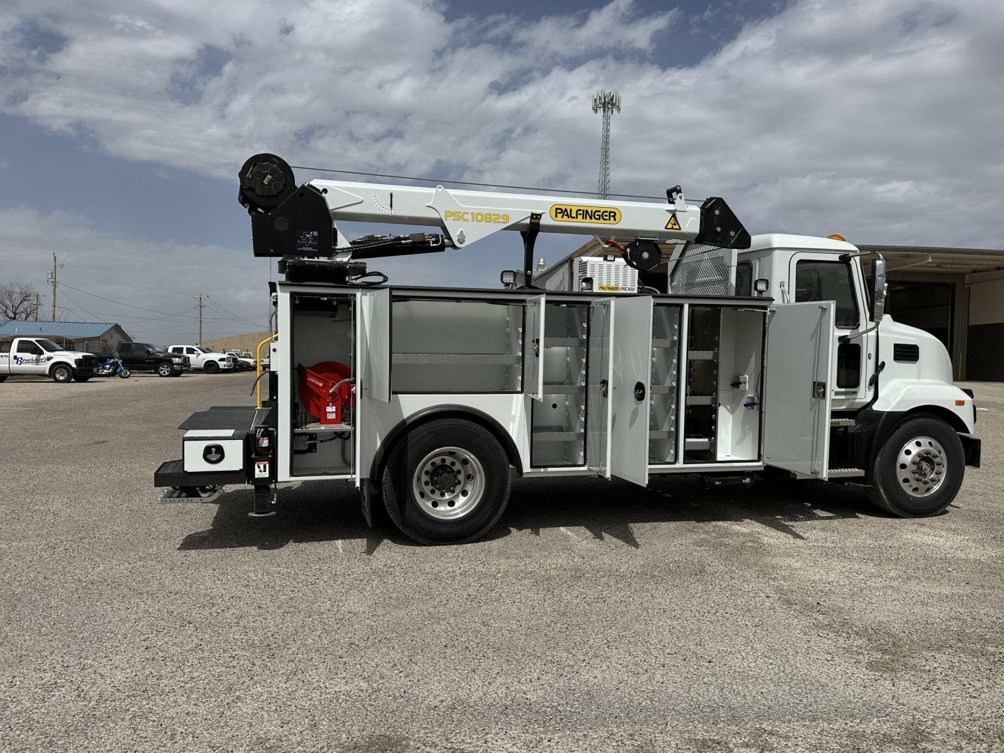 Service/Utility truck with Palfinger crane and multiple tool compartments, side view showing compartments and crane arm