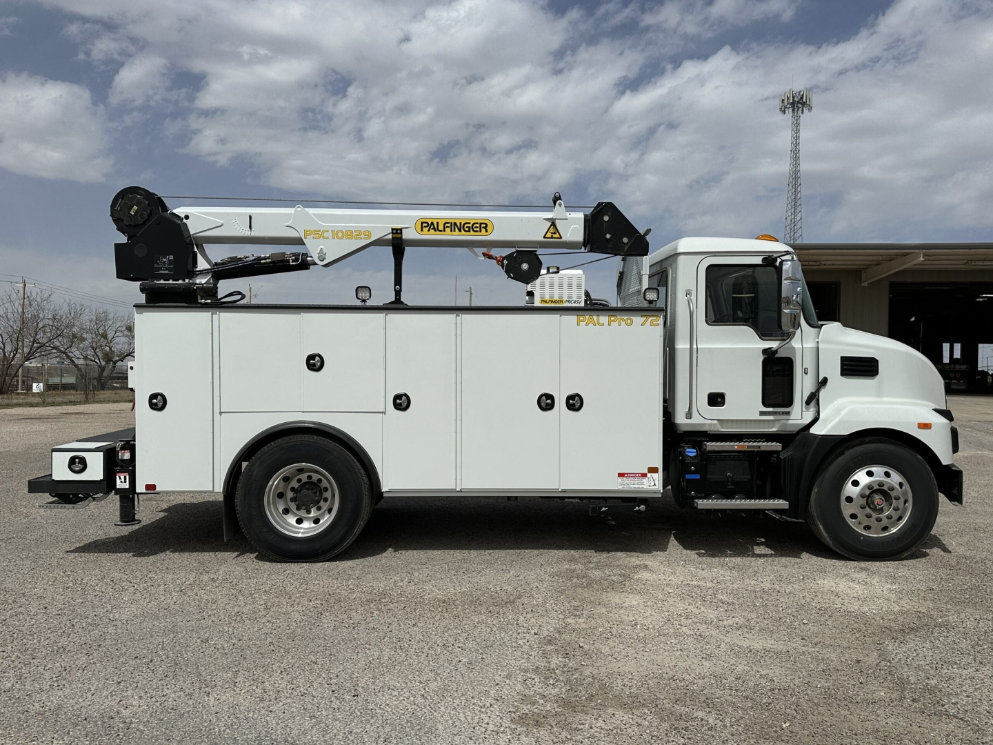 Panel van body showing Palfinger PK crane mounted on service truck with white cab and utility compartments.