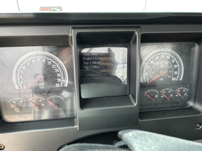 Dashboard view of a 2025 Mack MD7 showing instrument gauges, center display with trip information, and steering column area.