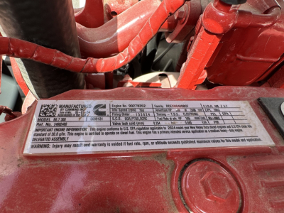 Mack MD7 engine bay plate showing model and serial details, VIN partially visible, red engine components and label with specs
