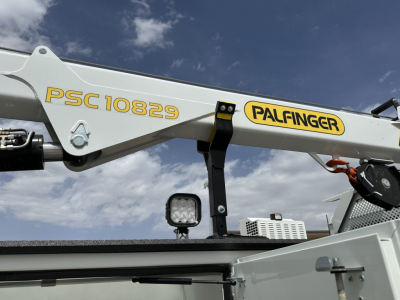 Palfinger crane arm with PSC 10829 markings and a small square LED work light in the foreground.
