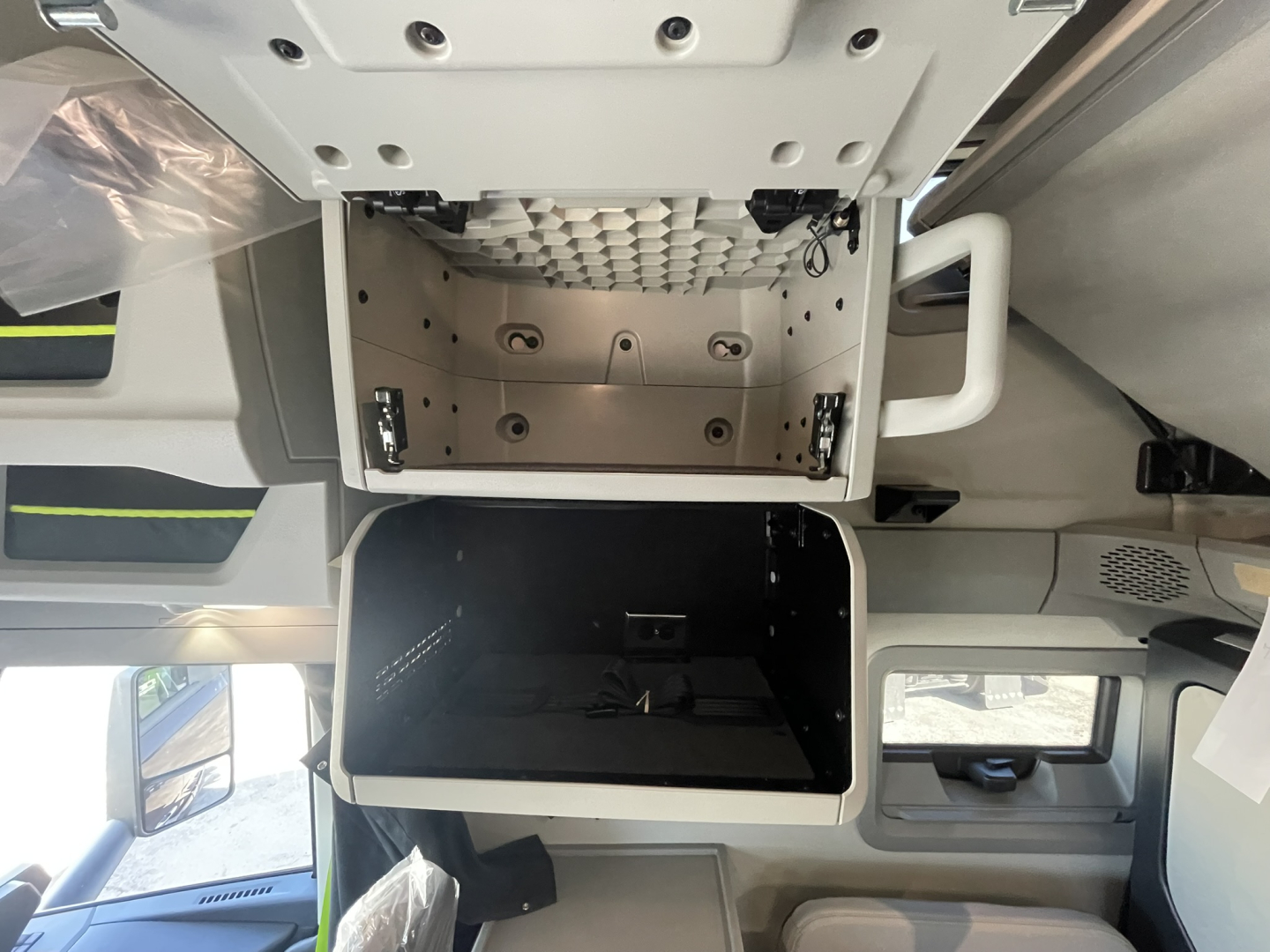 Volvo VNL64T860 cab interior showing overhead storage compartment and open bunk area with storage box