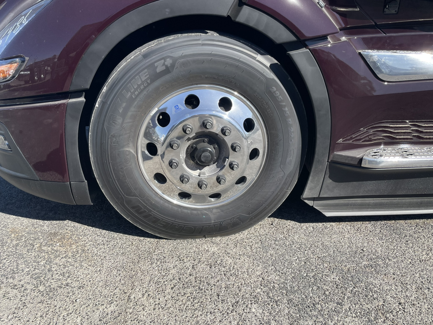 Volvo VNL64T860 front wheel showing steel wheel with multiple lug holes and tire.