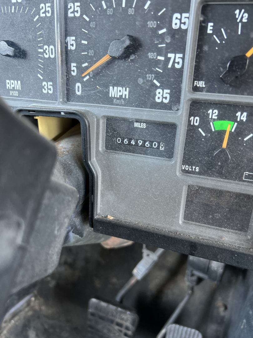 Dashboard of a 2000 International Navistar 3800 showing speedometer with MPH scale, odometer reading 064960, fuel gauge, and other gauges.