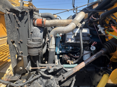 Engine bay of a 2000 International Navistar 3800 showing cooling system hoses, radiator, and engine components