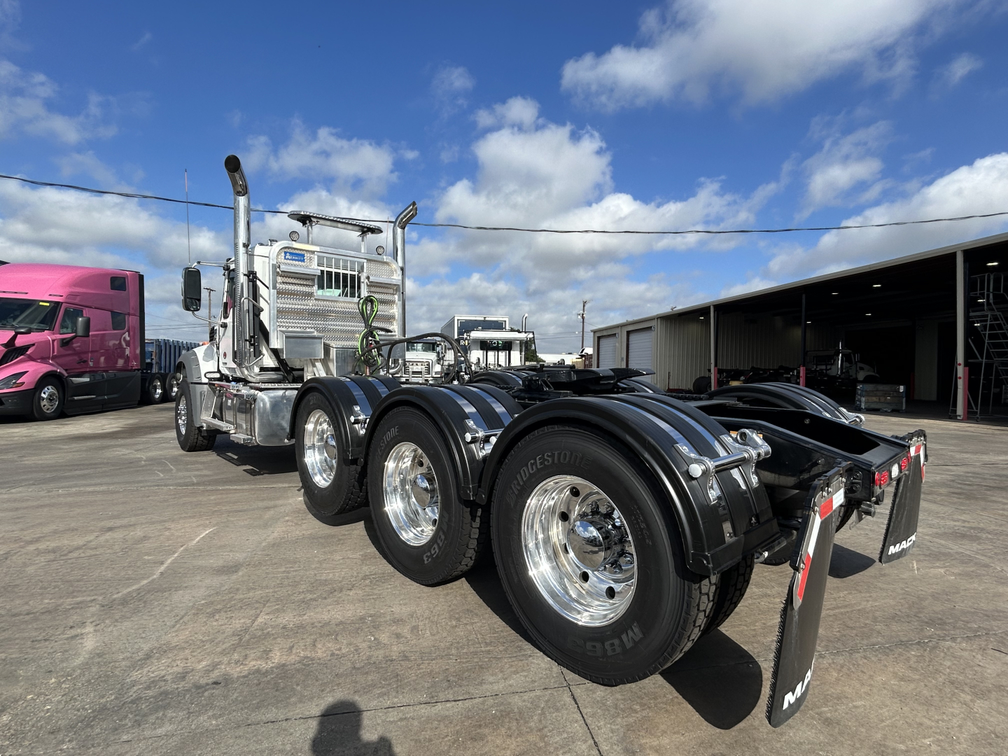 Mack GR84FT prime mover tractor showing dual rear axles and chrome exhaust stacks with polished wheels.