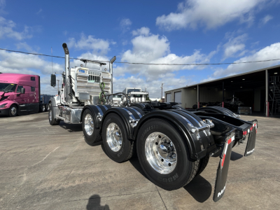 Mack GR84FT prime mover tractor showing dual rear axles and chrome exhaust stacks with polished wheels.