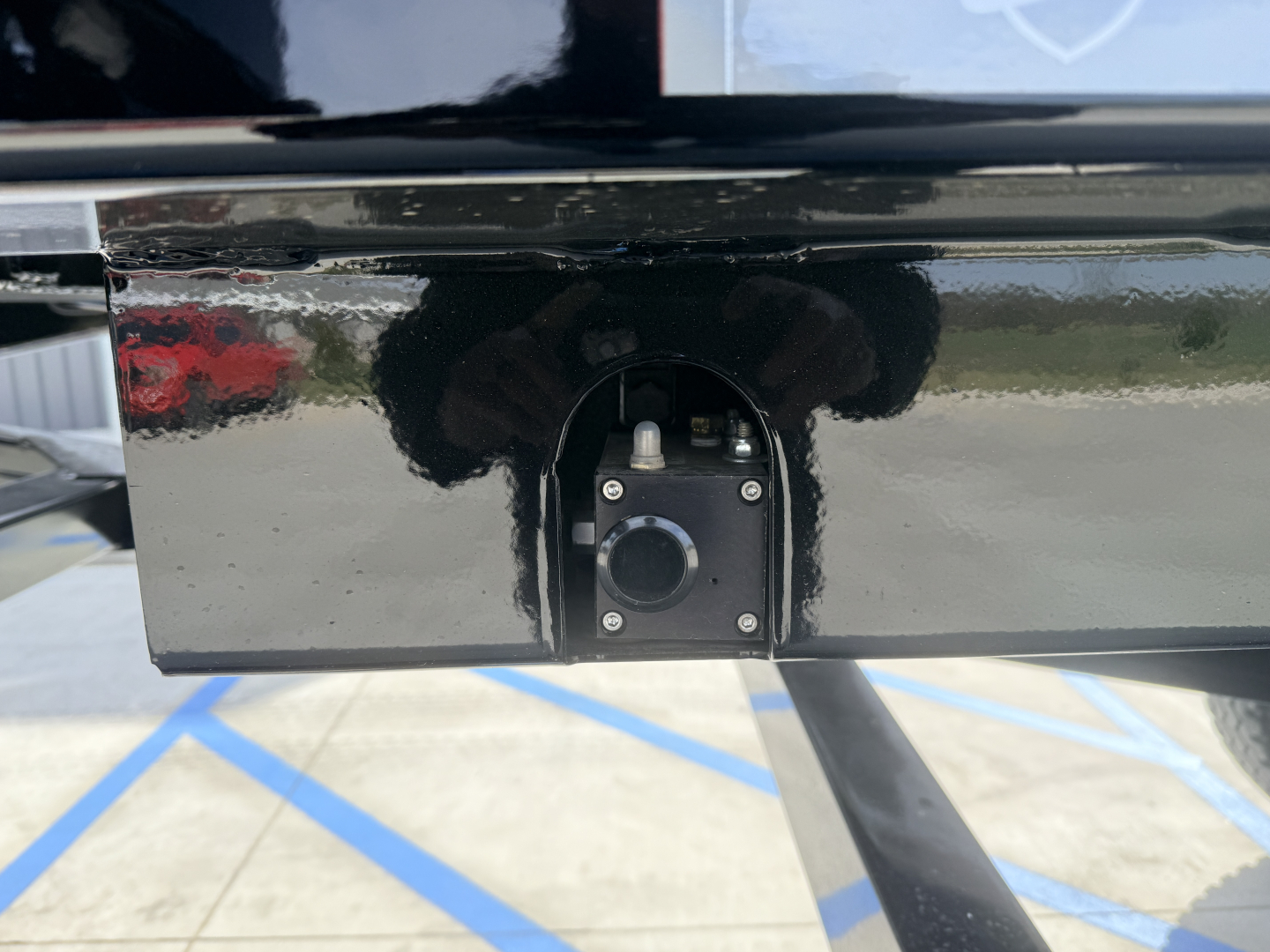 Trailer hitch area of 2027 Armor Lite SHD 28/48 showing rear frame and coupling socket with circular inlet and bolts.
