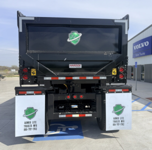 Dump trailer back view with Armor Lite logo, HarDOX label, and reflective tape. White mud flaps show Armor Lite Trailer Mfg contact; RGB lights and license area visible.