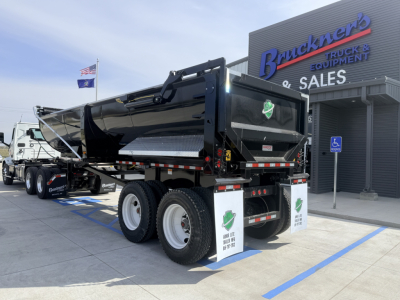 Armor Lite SHD 28/48 dump trailer in a dealership lot, side and rear views, black dump body, dual axle with 8 tires, brand stickers and safety decals visible.