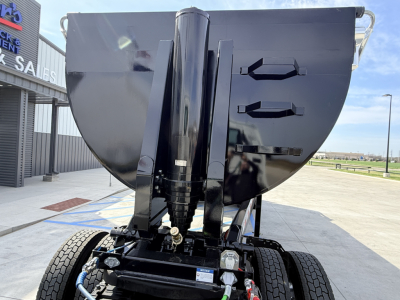 Dump trailer showing front of new Armor Lite SHD 28/48 1/4 frame single point hitch with dual vise-like arms and hydraulic components.
