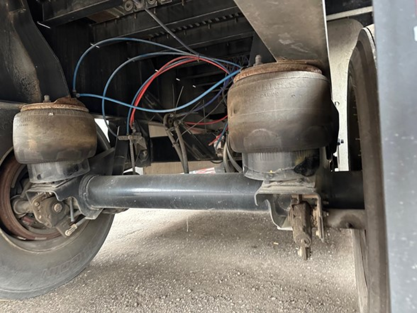Fontaine INFINITY flatbed trailer rear view showing dual air springs and suspension components with wiring harness