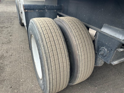 Twin rear tires of a Fontaine Infinity trailer showing dual tires and undercarriage components.