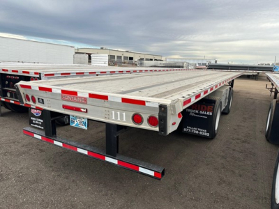 Flatbed trailer showing Fontaine branding and flatbed deck with red and white reflective stripes, rear lights, and bumper guard.