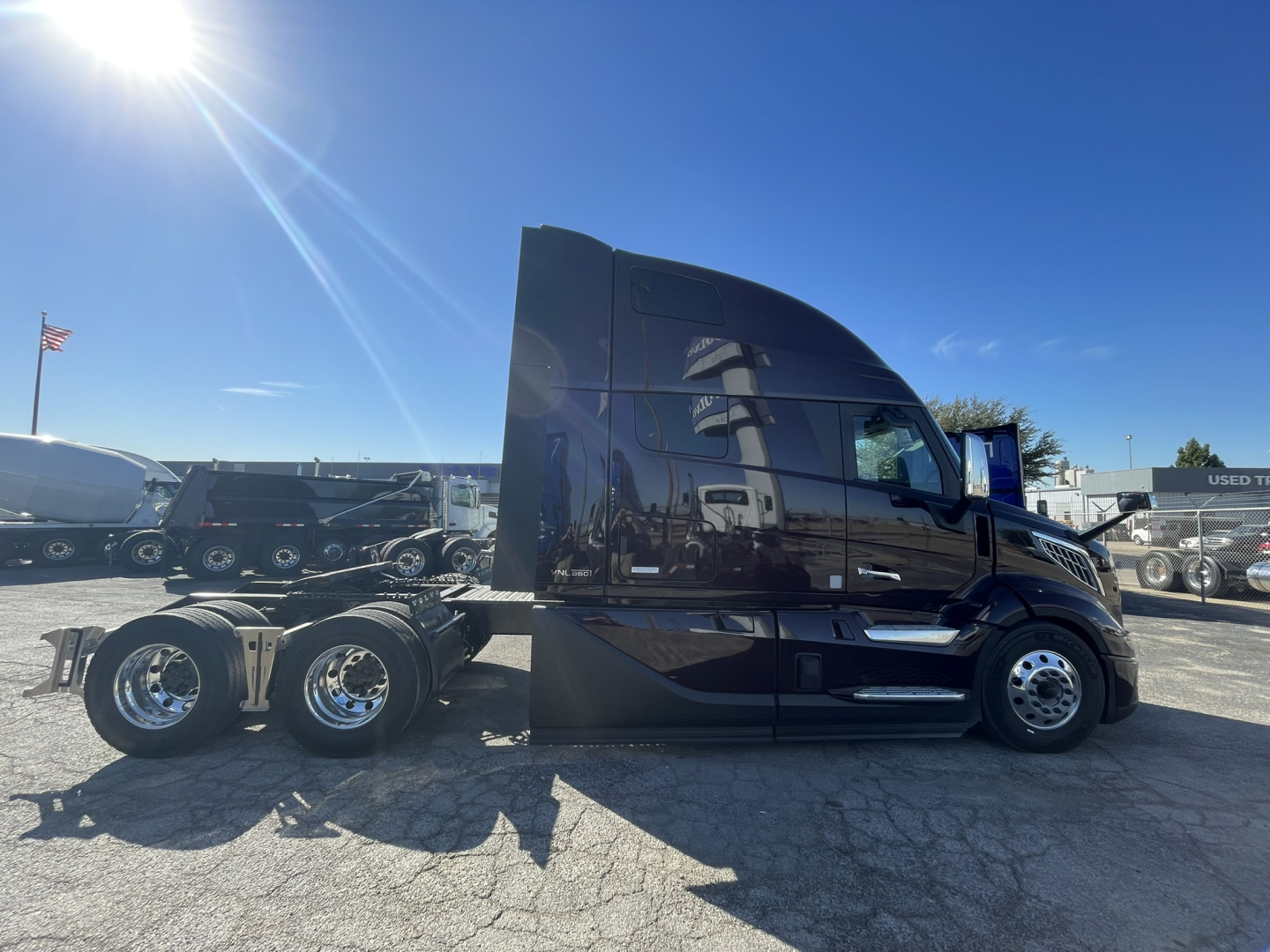 Volvo VNL64T860 truck cab and chassis side profile showing large sleeper cab, black paint, chrome wheels, and dual rear axles.