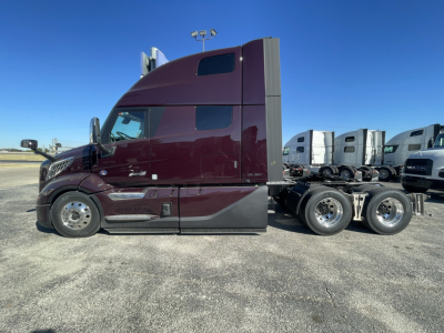 Volvo VNL64T860 tractor side view showing sleeper cab and rear axles.