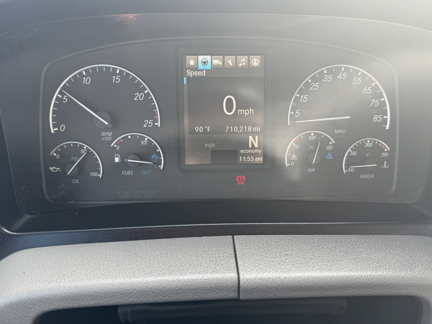 Dashboard view of a Freightliner PT126064S Daycab showing digital speedometer at 0 mph and gauges for oil, fuel, air, and coolant.