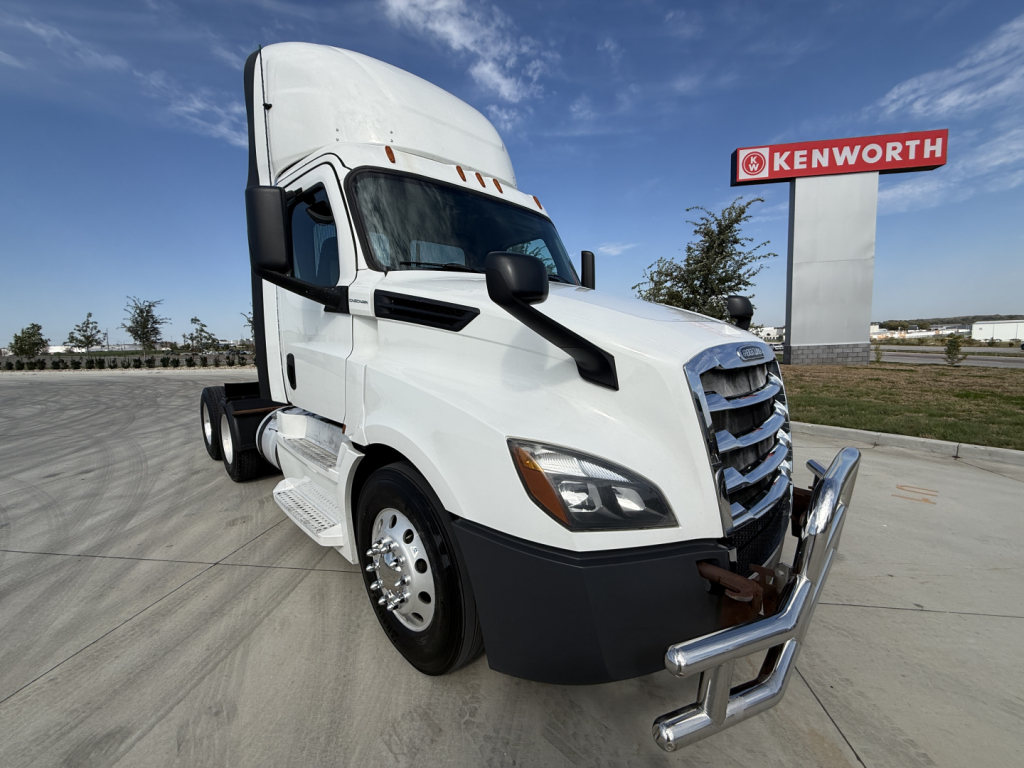 Truck cab exterior showing 2020 Freightliner PT126064S T with chrome bumper guard and large side mirrors.