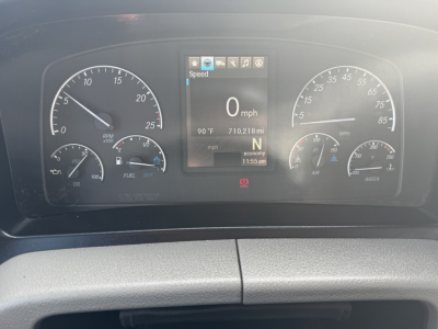 Dashboard view of a Freightliner PT126064S Daycab showing digital speedometer at 0 mph and gauges for oil, fuel, air, and coolant.