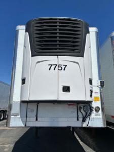 Rear view of a 2018 Utility 3000R W refrigerated trailer showing model number 7757 and refrigeration unit grille.