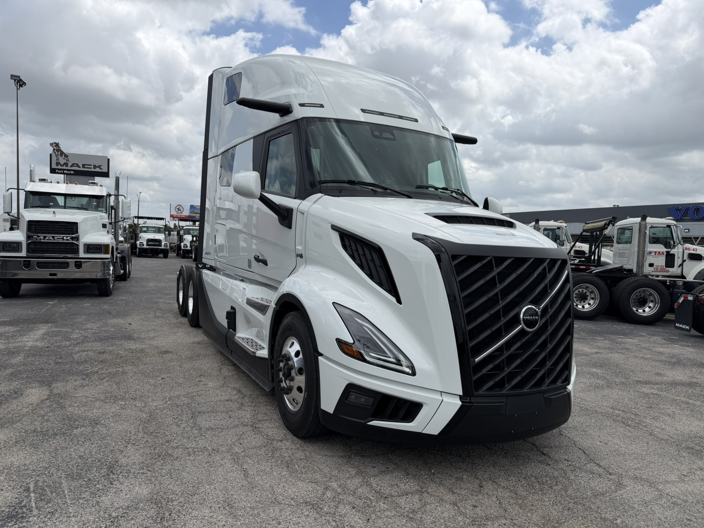 Volvo VNL64T860 truck in dealership lot with white cab and black grille, front-left view, stock number 72439 visible.
