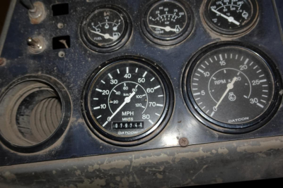Dashboard panel with multiple gauges including speedometer showing MPH, odometer reading 019,? miles, RPM gauge, fuel, air pressure gauges; Datcon labeling visible.