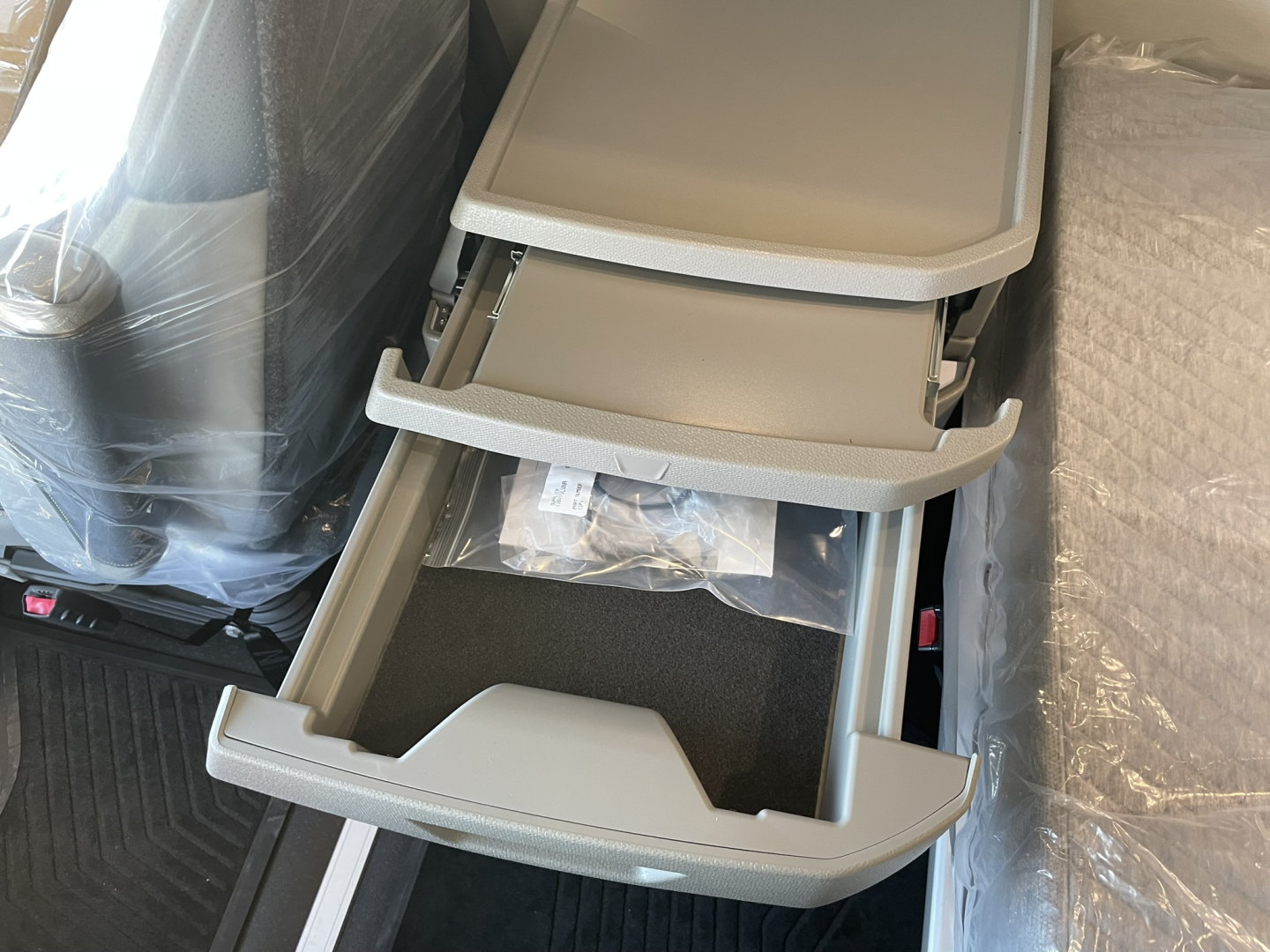Volvo VNL64T860 interior showing center console with open storage compartments and fold-out steps.