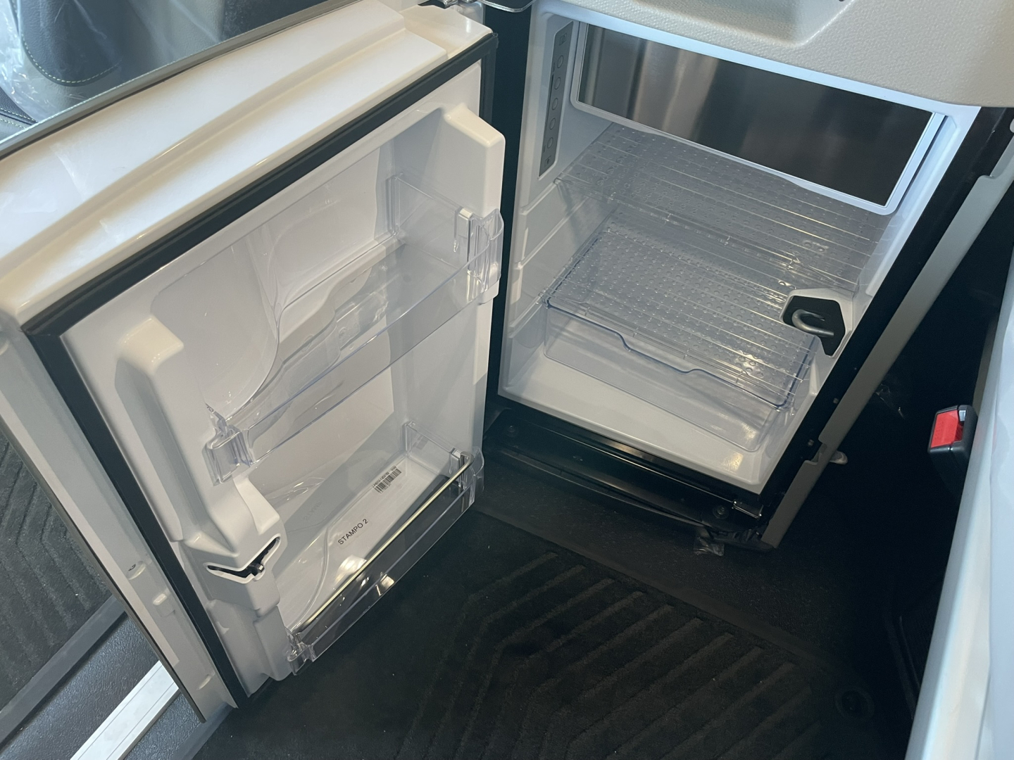 Volvo VNL64T860 truck interior showing open refrigerator and freezer doors in a sleeper cab
