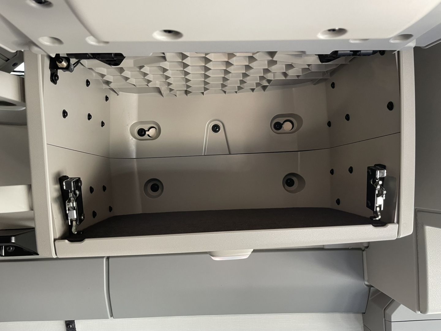 Volvo VNL64T860 sleeper cab storage drawer open showing interior compartments and mounting rails.