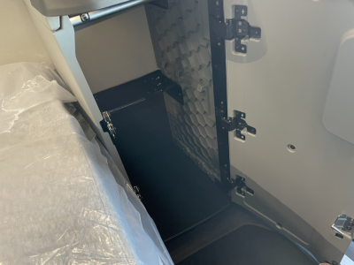 Volvo VNL64T860 truck cab interior detached panel showing storage area and hinges.