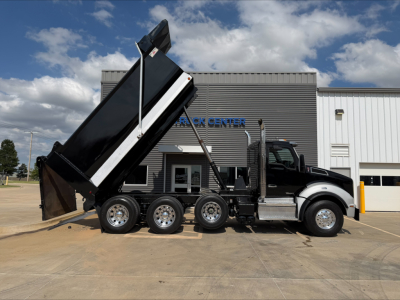 Kenworth T880 dump truck side profile with lifted bed showing six-wheel configuration and dump bed.