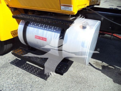 Diesel fuel tank and side view of a yellow dump truck bed with black steps and metal brackets.
