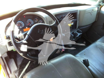 Truck interior showing steering wheel, dashboard gauges, and center console of a 2019 International 4300 dump truck.