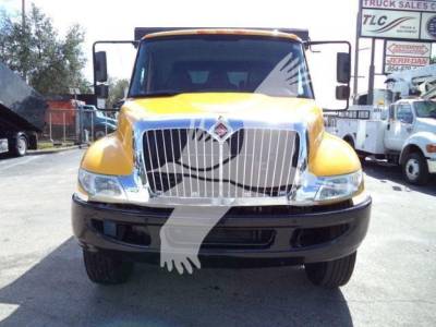 Front view of a yellow 2019 International 4300 dump truck showing prominent grille, headlights, and bumper.