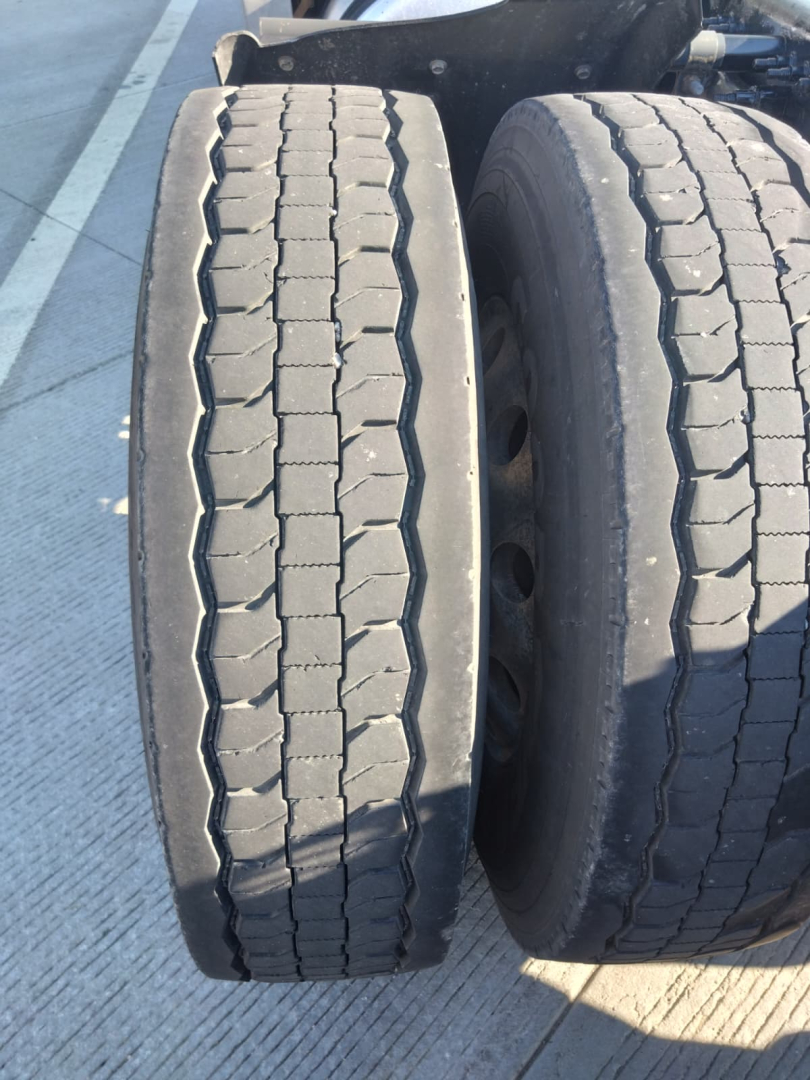 Truck wheel pair showing tread pattern on Freightliner Cascadia dual rear axles.