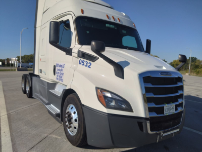 Freightliner Cascadia tractor cab in white, front-right view, with cab numbers 0532 and front grille visible.