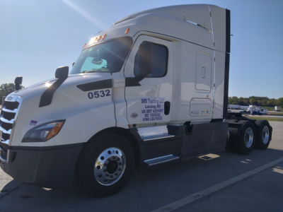 White 2020 Freightliner Cascadia Conventional Sleeper truck showing cab, bumper, and dual rear axles with company markings and VIN plate.