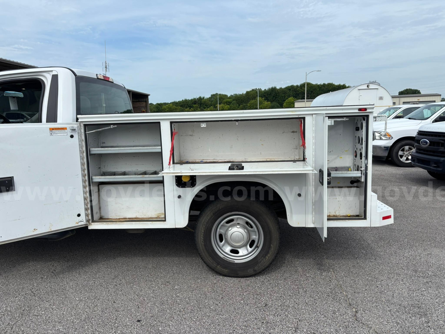 Service/Utility Ford F-250 utility body side compartments with open storage bays and shelving.
