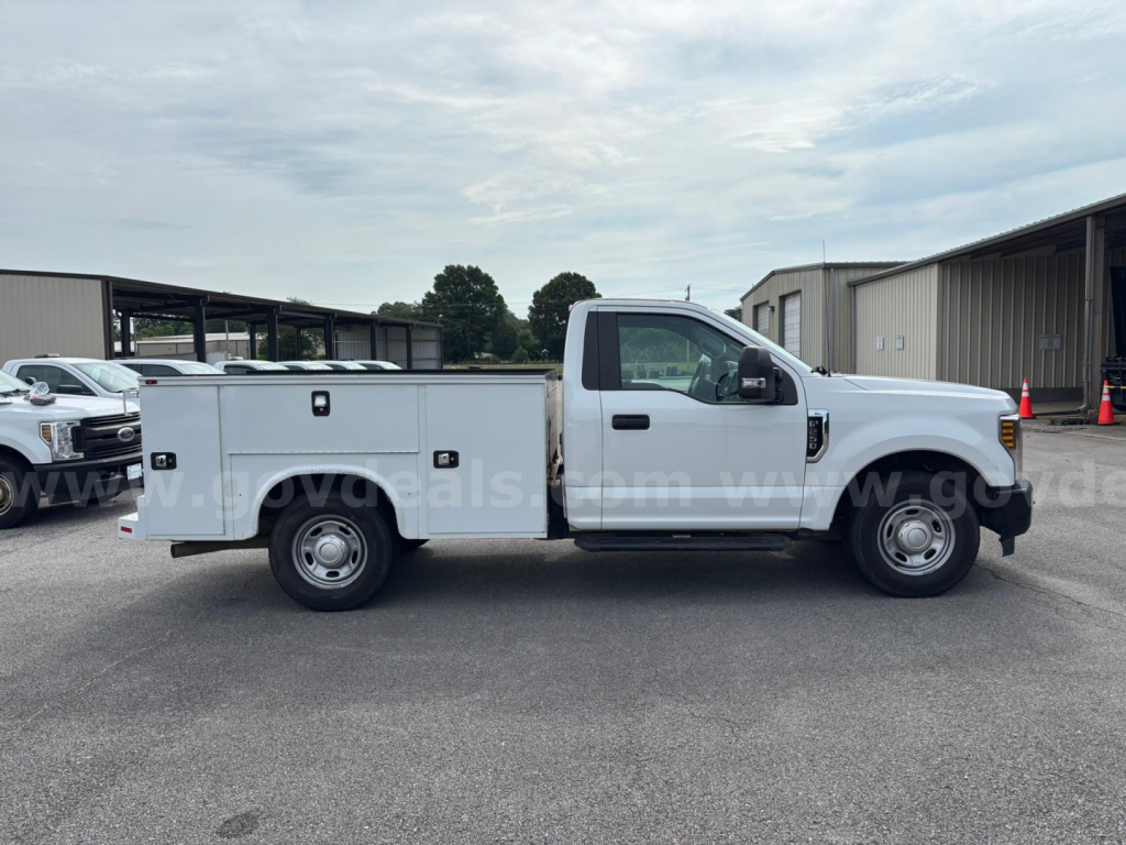 2019 Ford F-250 single cab utility truck side view with service bed and storage compartments.