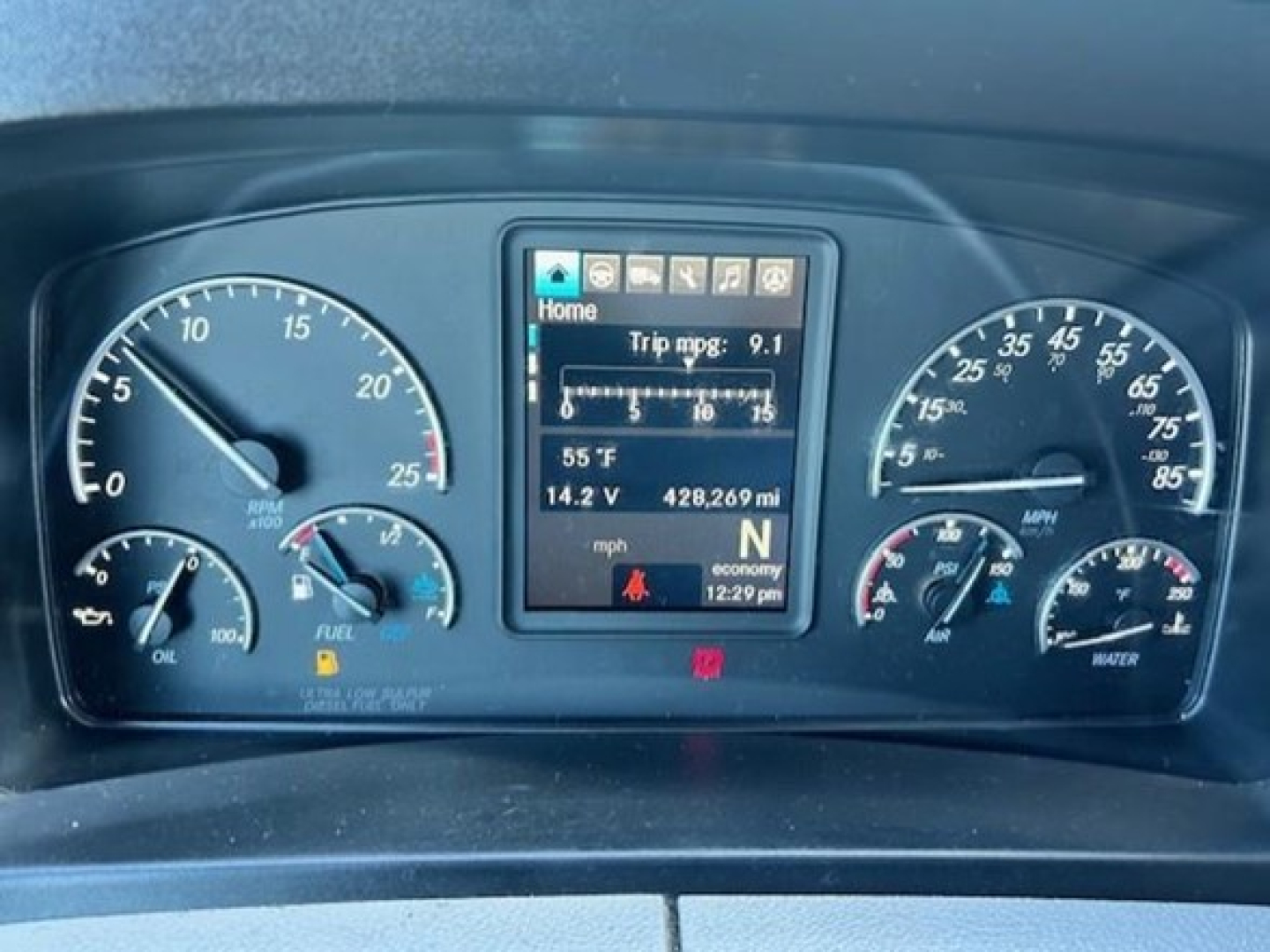 Dashboard of a 2022 Freightliner Cascadia 126 showing multiple gauges and a center digital display with trip mpg, 55 F, 428,269 mi, wheel controls, and indicators.