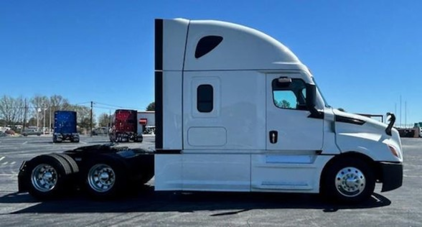 Truck side view of a 2022 Freightliner Cascadia 126 conventional sleeper showing exterior cab with sleeper, white paint, and chassis behind.