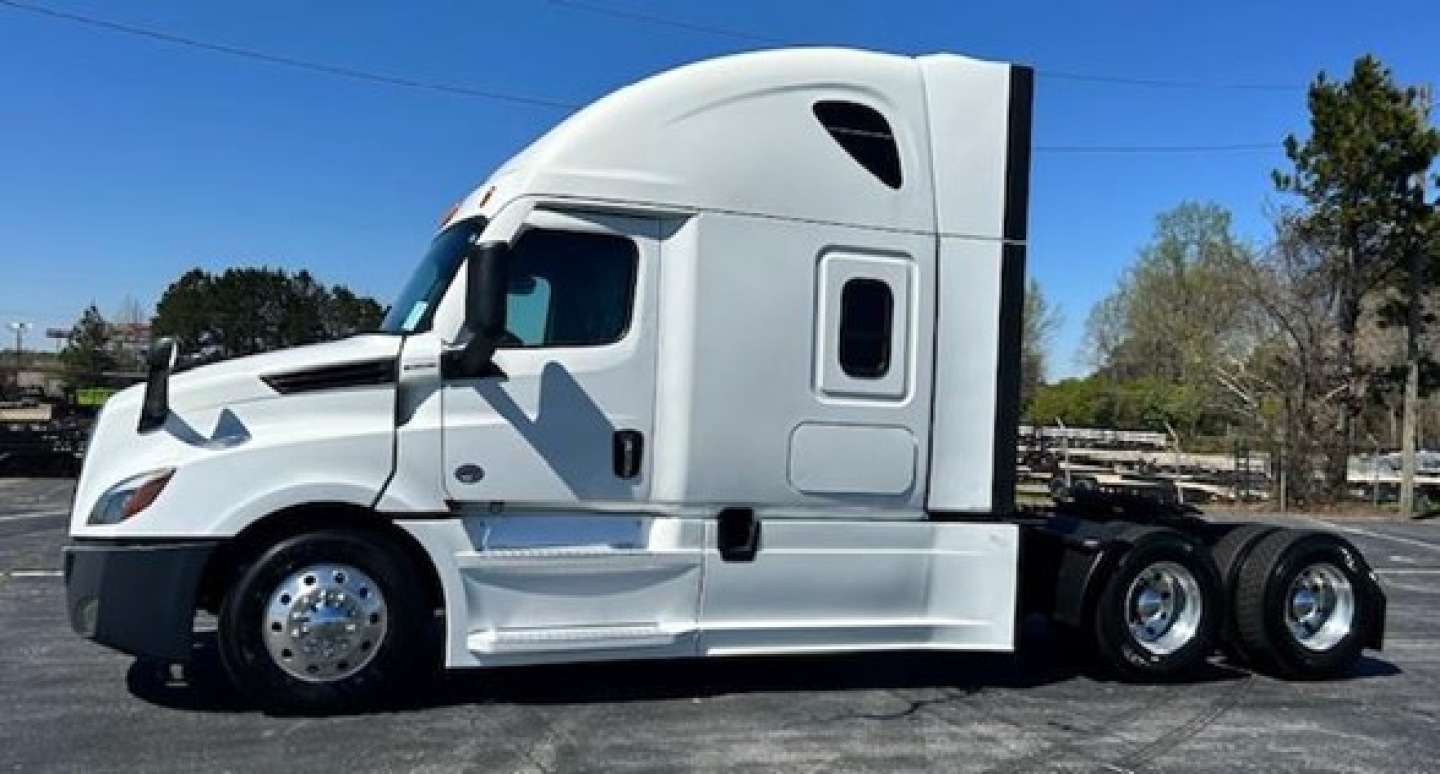 Truck cab and chassis of a 2022 Freightliner Cascadia 126 conventional sleeper showing side profile and wheels.