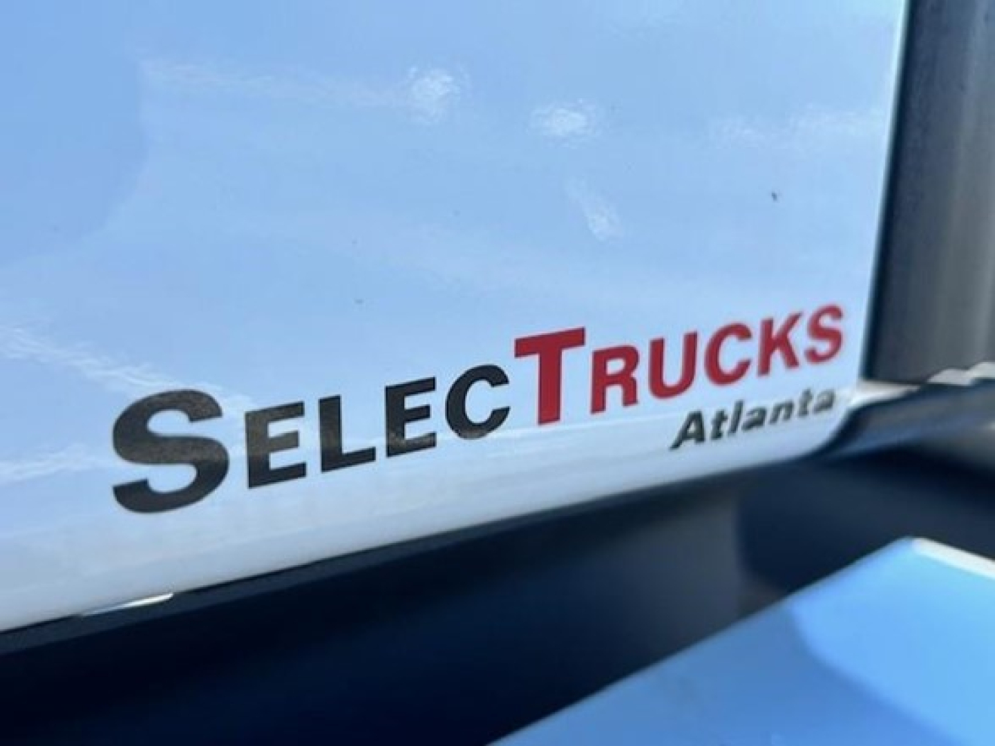 Truck cab window with SelecTrucks Atlanta decal visible.